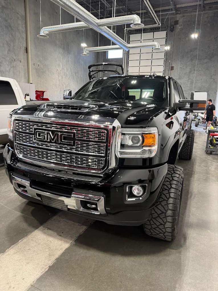 Black GMC Sierra Denali truck detailed to a mirror shine in the detail bay